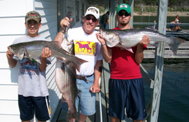 Alex, Doug, & Adam, Doug is holding a 22 lb striper, they fished with Norfork lake guide service STR Outfitters