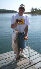 Doug holding his 22 lb striper, caught with Tom Reynolds Norfork stripers & STR Outfitters